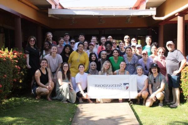 Shenandoah health professions and pharmacy students and faculty gathered around a Shenandoah banner in Nicaragua in 2024.